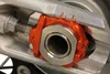Works Orange Aluminum Elite Axle Block Pair