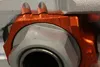 Works Orange Aluminum Elite Axle Block Pair